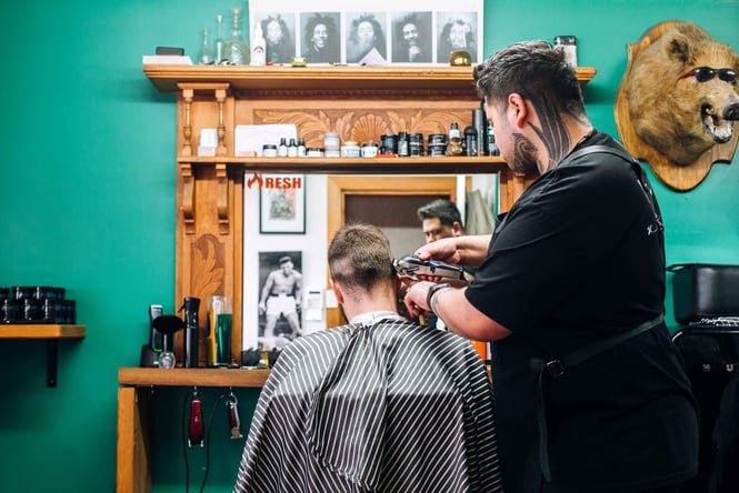 Barber giving man a hair cut.