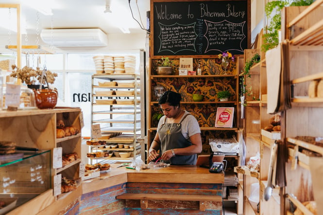 Bakery interior with shelves of breads.