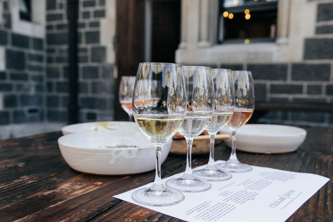 Row of wine tasting glasses outside on a table at Cellar Door in Christchurch.
