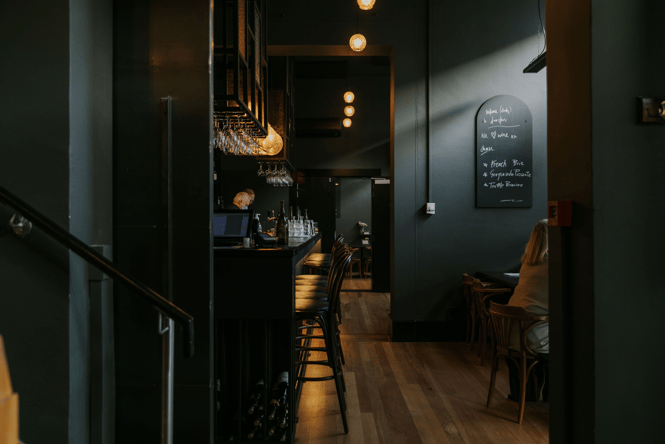 Dark moody image inside Downstairs where their is bright feature lighting.