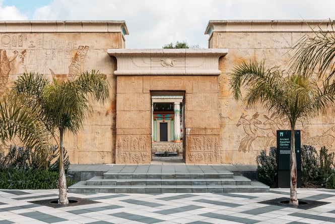 The tall sandstone-coloured walls at the entrance to the Ancient Egyptian Garden.