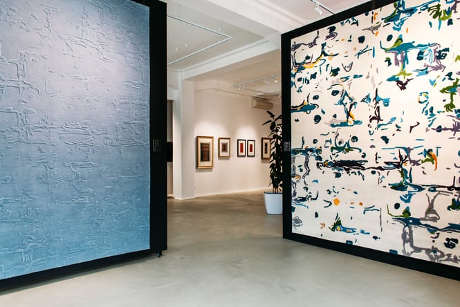 Two giant rugs on display like paintings inside Hanrad Bespoke Rugs.