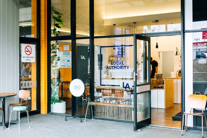 Glass exterior with gold and black signage.