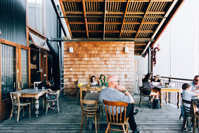 Customers hanging out on the deck at Lyttelton Coffee Company cafe.