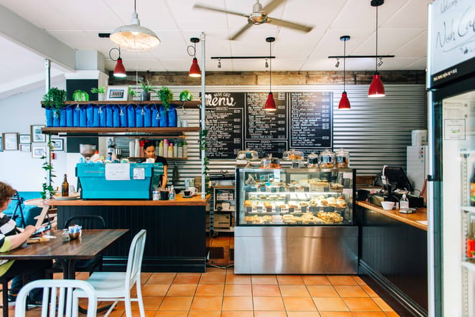 View of coffee machine and menu on the wall.