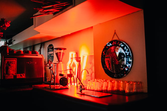 Red light decorations shines on drinks.