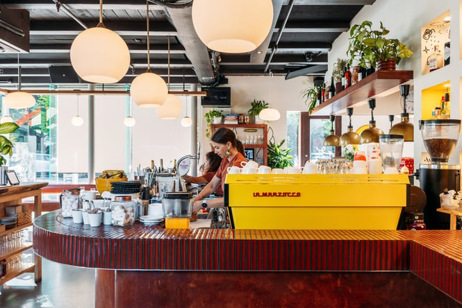A bright yellow coffee machine in Odd Saint Queenstown.
