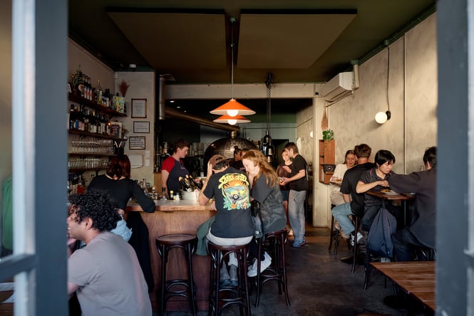 Looking through the doorway into a busy dining room at OOH-FA in Auckland