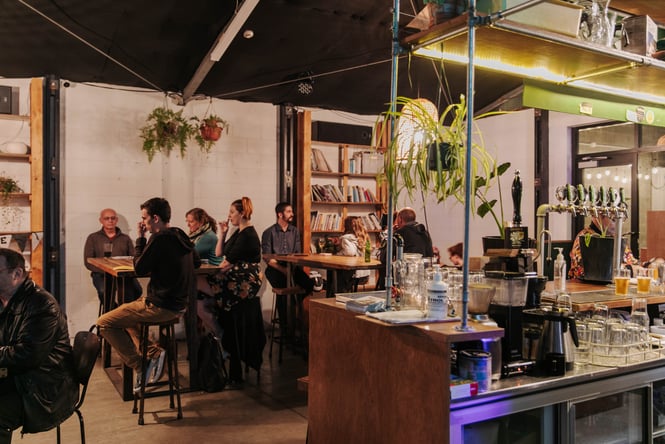 Customers sitting at high tables.
