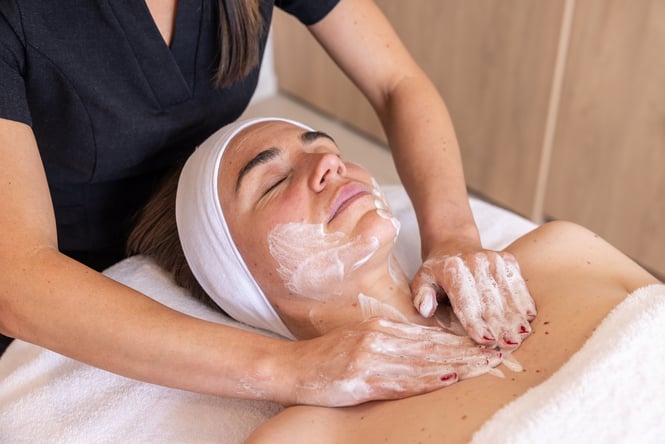 Close up of woman receiving a facial.