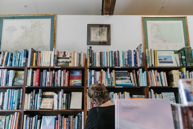 Woman looking at books at Smith's Bookshop, Christchurch.