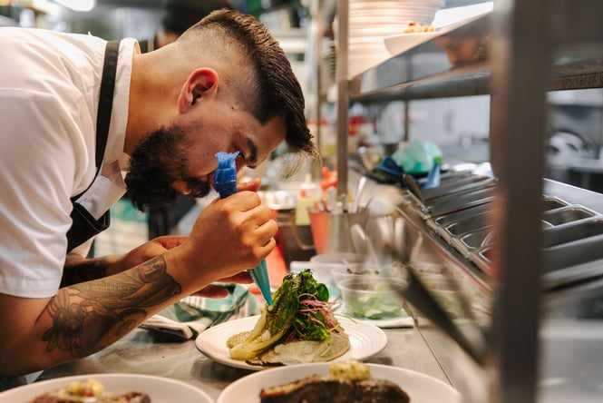 Chef preparing dish.