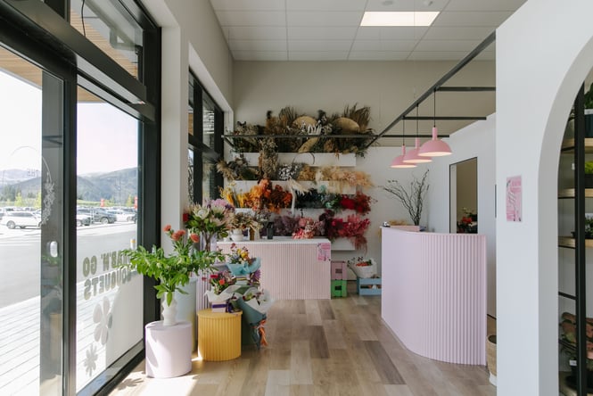 The interior of The Green Room flower and plant store with light pink counters.