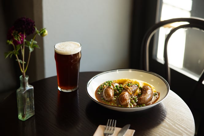 A beer and bangers and mash on a table at Victoria Free House Christchurch.