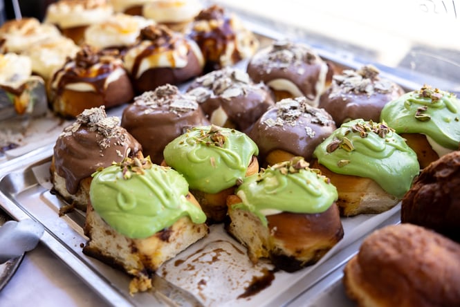 Tray of cinnamon rolls with colourful icing at Zoyi.