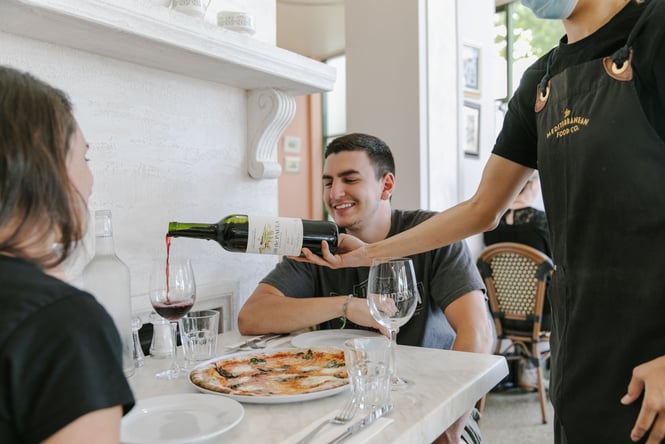 Couple dining on pizza at Mediterranean Foods.