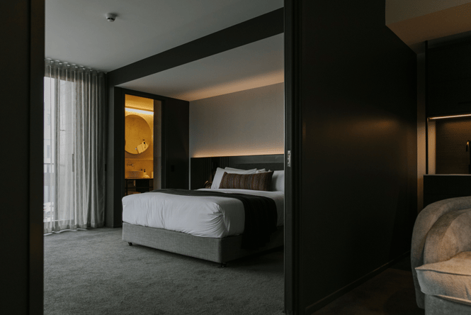 View looking through the door from the lounge to the bedroom inside Christchurch accommodation.
