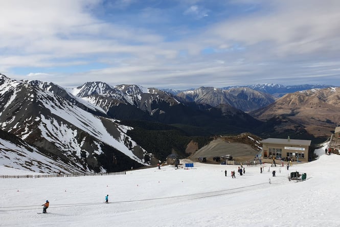 People on Mt Cheeseman ski field on a sunny day.