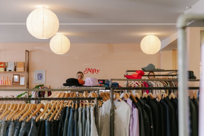 Rows on clothes inside a second hand clothing store.