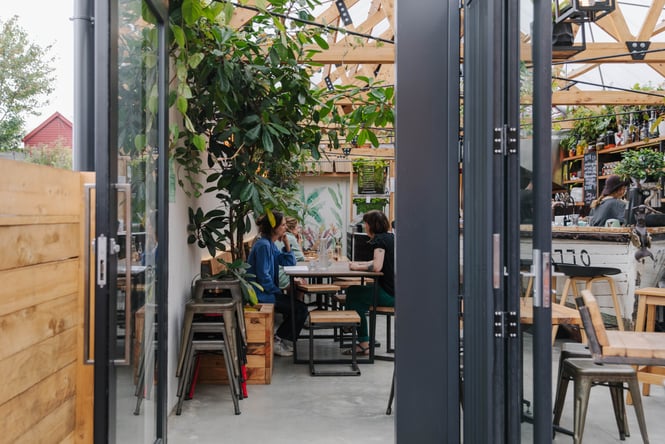 Looking through a doorway into Arbour Woodfire Pizza.