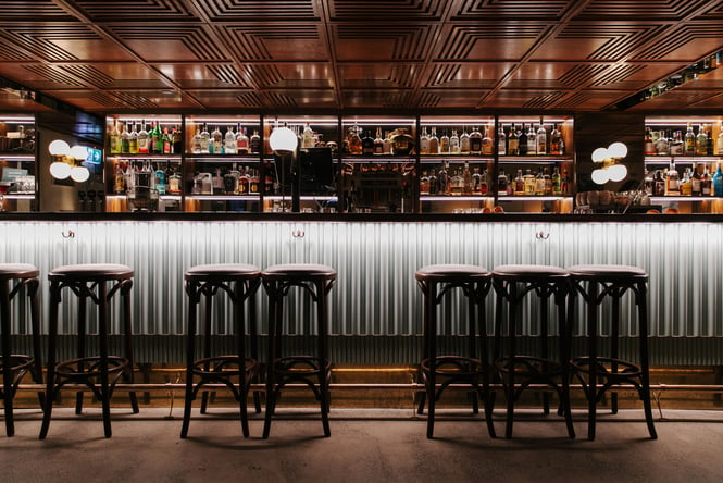 View of the bar and wooden panelled ceiling at Austin Club.