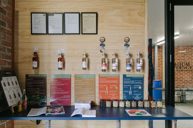Humdinger Gin bottles hanging on the wall.