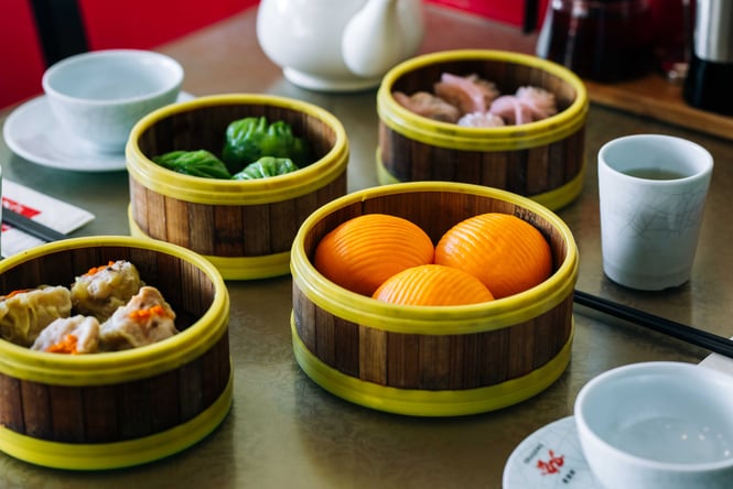 A table full of Chinese food on a table inside Dragons Wellington.