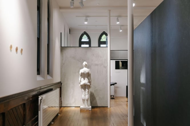 A white statue in the Absolution exhibition space.