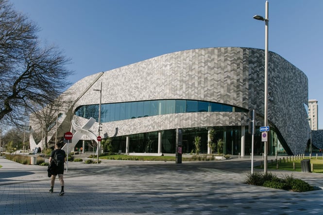 A building with a big glass window on the side.