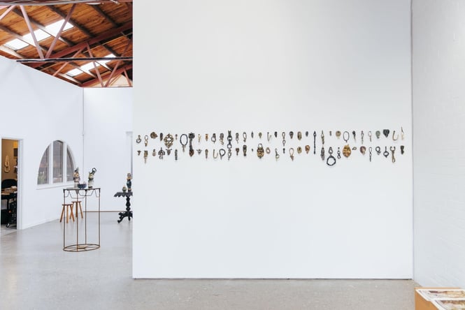 Small objects are featured on a wall at The National.