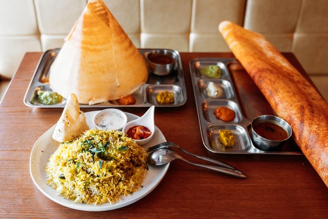 Plates of Indian food on a table.