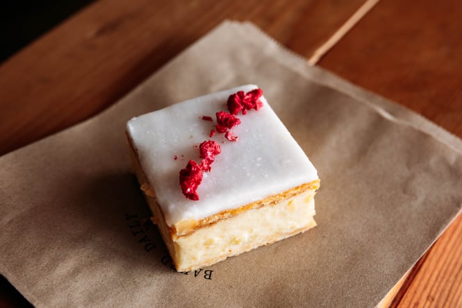A custard square on a wooden table.