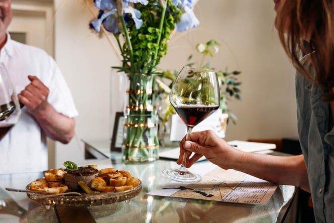 A customer enjoying a wine tasting at VALLI Wine Bar in Kurow..