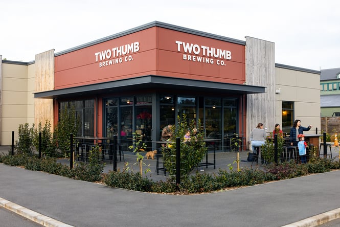 Exterior of Two Thumb Brewing Co Harbourside with diners seated outside