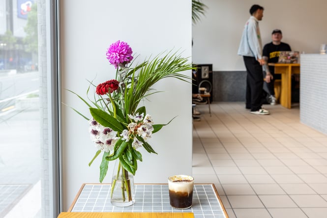 Viral Mont Blanc drink on tiled coffee table next to a vase of flowers at Rook