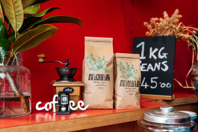 Coffee beans and equipment sitting on a shelf at Mana Coffee.