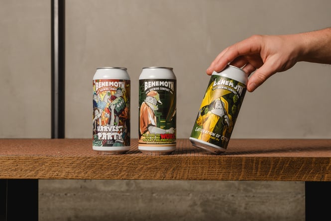 Three cans of beer sitting in row.