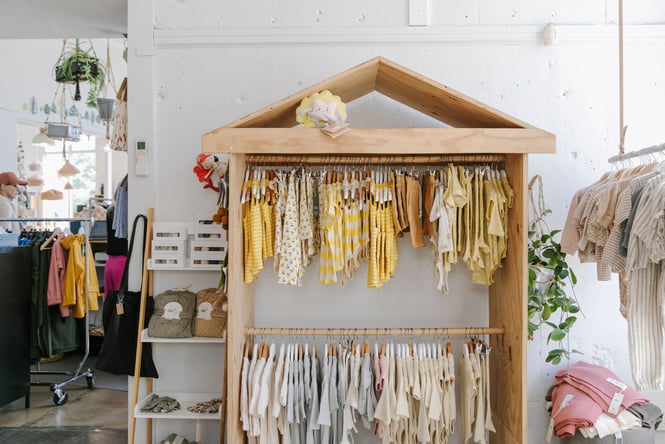 Rack of yellow kidswear at William Bee in Oamaru