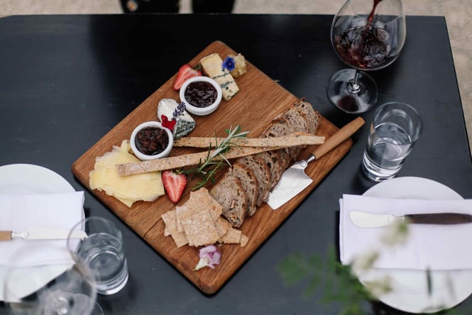 A Birdseye view of a cheese platter on a table at Black Estate.