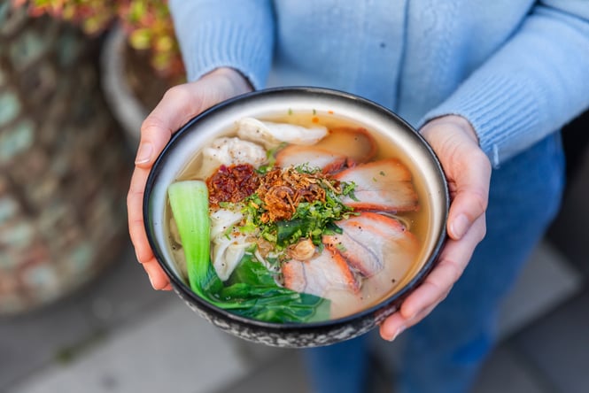 Someone holding bowl of wonton soup from BB Vietnamese in the BNZ Centre Christchurch