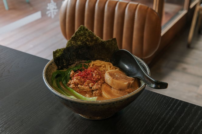 Bowl of ramen soup topped in nori and pork slices from Tanoshi in Christchurch
