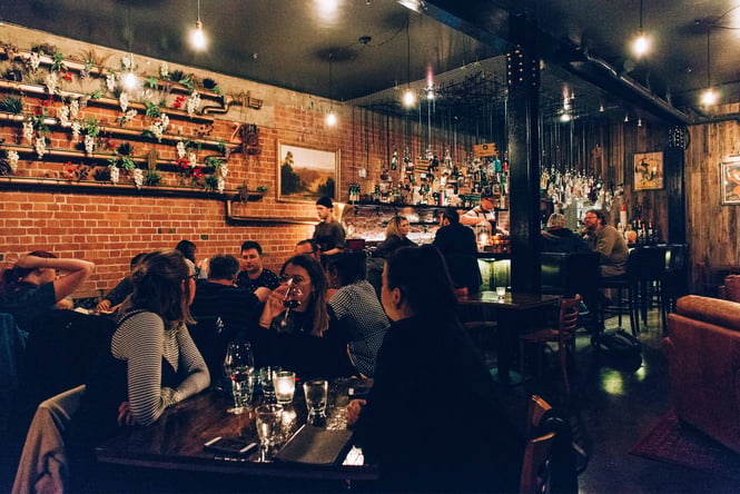 A bar full of people on a dark night.