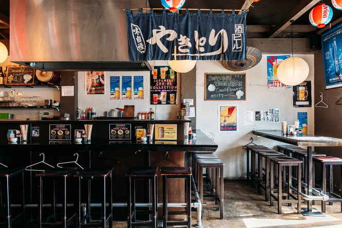 Bar area and bar stools in a Japanese restaurant.