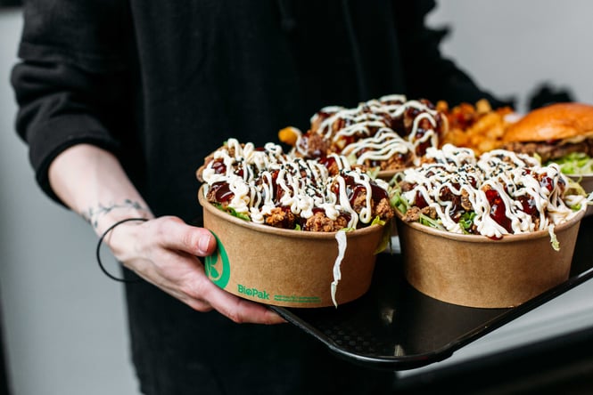 Pots of chicken and rice on a tray.
