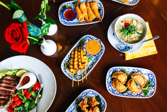 Plates of Thai food on a table at Tuk Tuk Thai Kitchen Porirua.