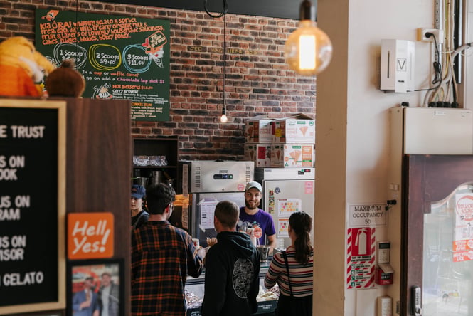 Customers being served at the counter by a staff member.