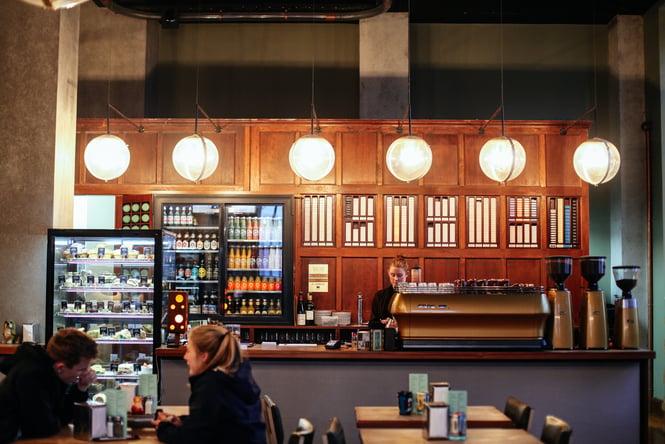 A staff member working behind the counter at C1 at night.