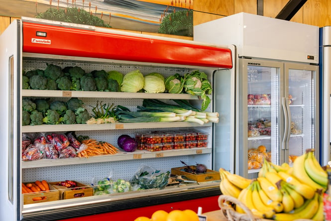 Fridge full of fresh vegetables and fruits.
