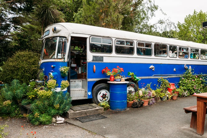 Blue bus that has been converted to a cafe.