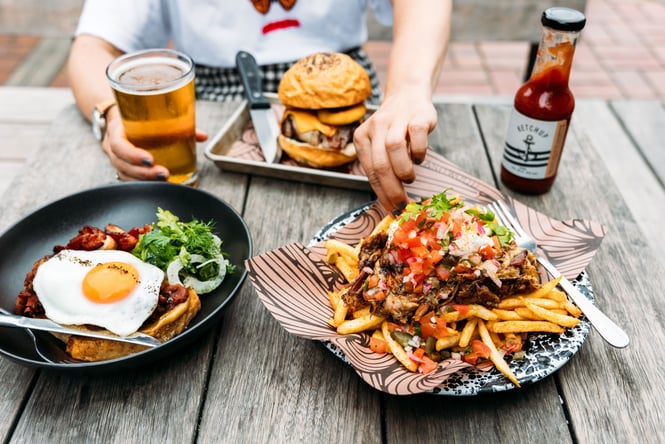 Burger and other dishes on the table.